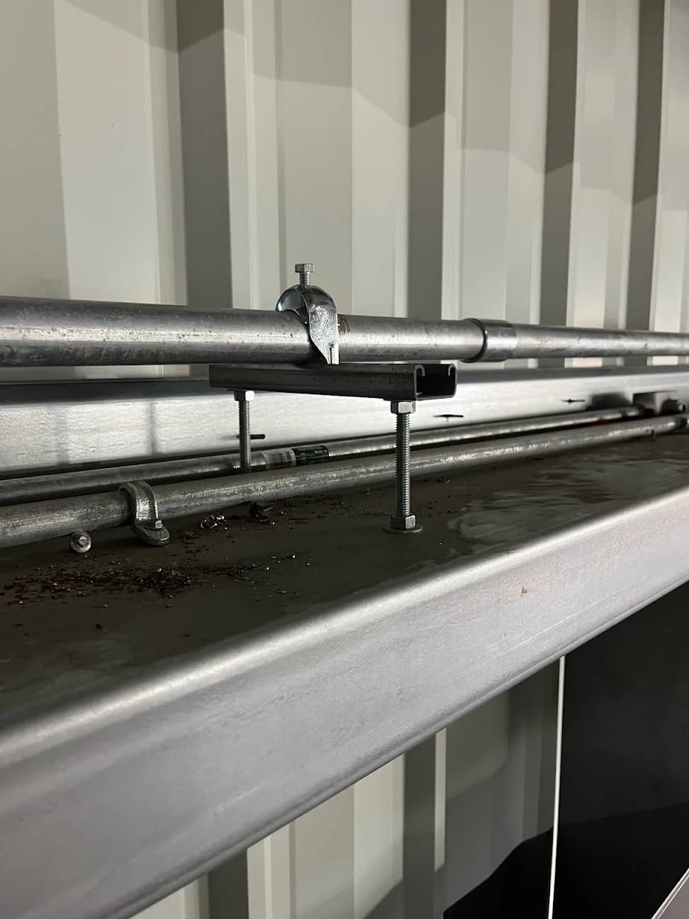 Conduit runs and supports along an interior metal wall
