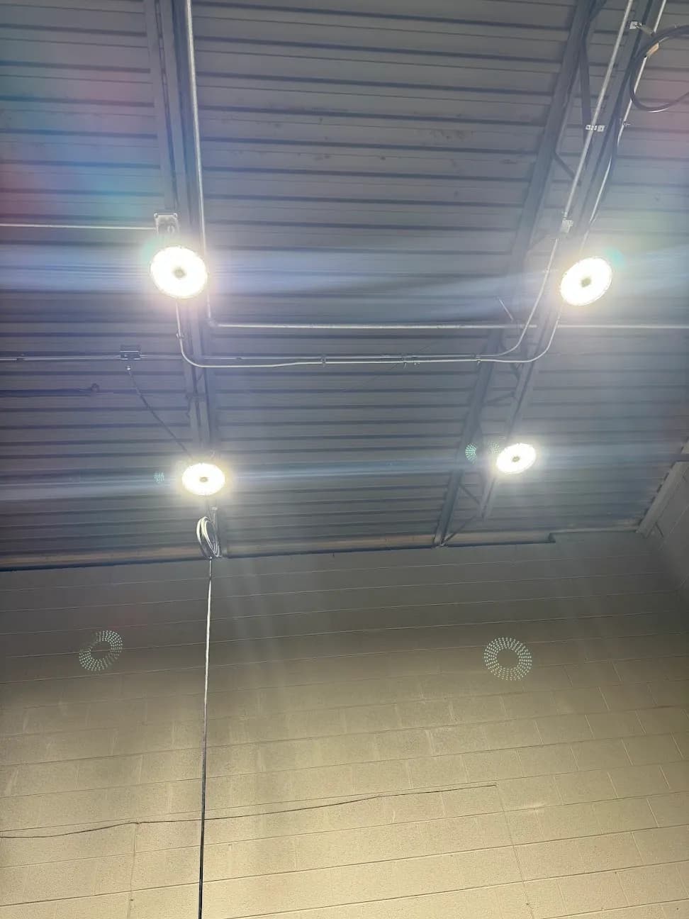 Recessed ceiling lights lit in a finished room